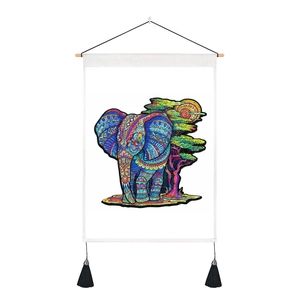 Detail of bohemian elephant wall scroll featuring colorful mandala art and black tassels