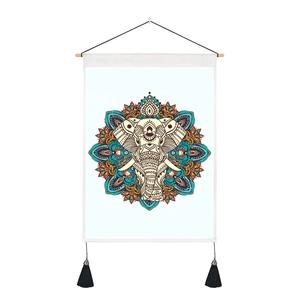 Detail of bohemian mandala elephant wall tapestry with wooden rod and black tassels