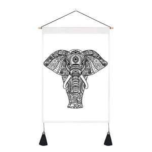 Detail of elephant mandala tapestry showing black tassels and wooden hanging rod