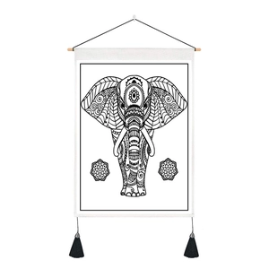 Detail of bohemian elephant mandala tapestry with wooden hanging rod and black tassels