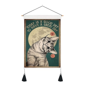Detail of vintage cat tapestry with cotton linen texture and black tassels for wall decor