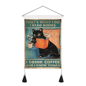 Close-up of vintage cat wall hanging with cotton linen texture and black tassels detail