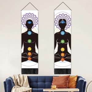Chakra-Yoga-Wandteppiche mit Quasten hängen über einem blauen Sofa in einem Zimmer