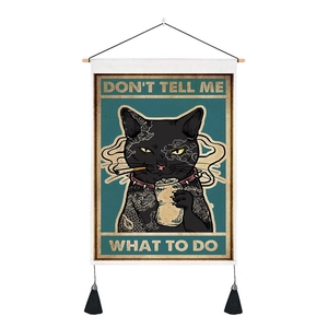 Detail of vintage cat tapestry with wooden rod, black tassels and Don't Tell Me What To Do text