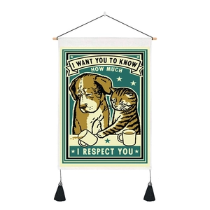 Detail of vintage cat and dog wall hanging with quotes and decorative black tassels