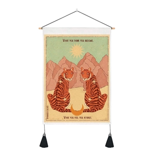 Detail of vintage tiger tapestry with motivational quotes and black hanging tassels