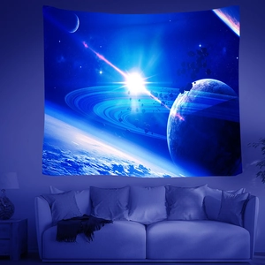 Stunning galaxy space planet tapestry wall hanging shown in a cozy blue bedroom setting