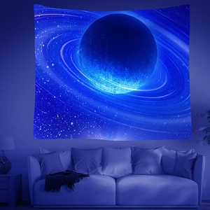 Detailed view of galaxy wall tapestry with planets and stars above a sofa for home decor