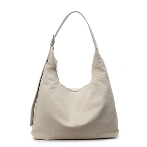 Minimalist beige large capacity hobo bag with adjustable strap on white background