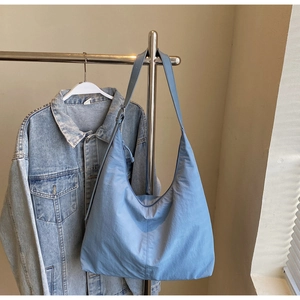 Close-up of light blue large capacity nylon hobo bag with adjustable wide shoulder strap