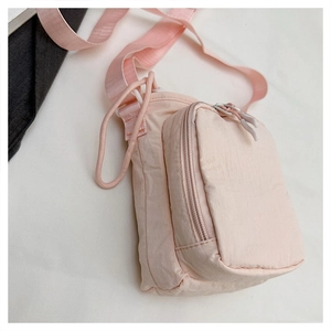 Detail of pink nylon crossbody bag with zip pocket and rope loop for outdoor sports