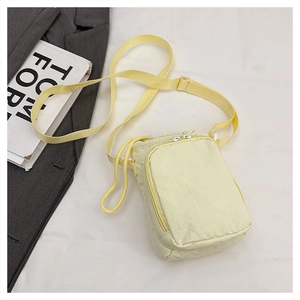 Light yellow waterproof crossbody bag for yoga with front zipper pocket and strap