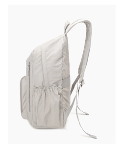 Side view of lightweight light grey nylon backpack with elastic pocket and adjustable straps