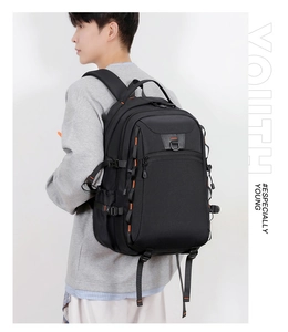 Detailed side view of black outdoor backpack with orange accents and wide straps