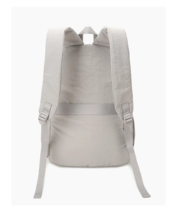 Detail of grey backpack back showing breathable padded straps and luggage trolley strap