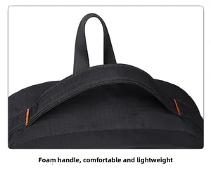 Detail of padded foam handle with orange stitching on durable black outdoor backpack