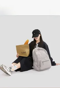 Detail of light gray nylon backpack with multiple pockets for outdoor casual travel