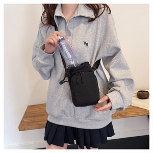 Detail of crossbody water bottle bag with drawstring closure and phone zip pocket