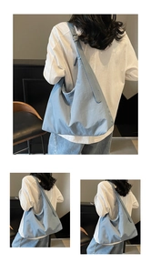 Detailed view of light blue nylon hobo bag with adjustable strap and large main compartment