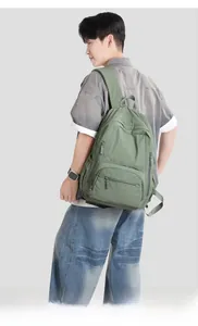 Detail of olive green nylon backpack showing tear-resistant fabric and large storage