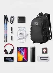 Flat lay of 20L black outdoor travel backpack with hiking gear and laptop storage