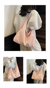 Detail of pink large-capacity hobo tote bag with soft pleated texture and adjustable strap