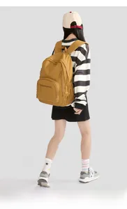 Detail of a mustard yellow lightweight nylon backpack with large capacity and multi-compartments