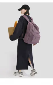 Detail view of purple nylon outdoor backpack showing large capacity side and shoulder straps