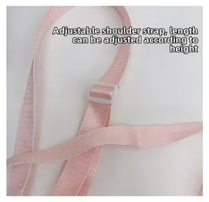 Close-up of pink adjustable nylon shoulder strap with white buckle for length control