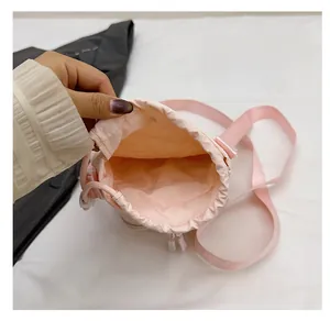 Close-up of pink drawstring crossbody bag showing the simple interior storage compartment