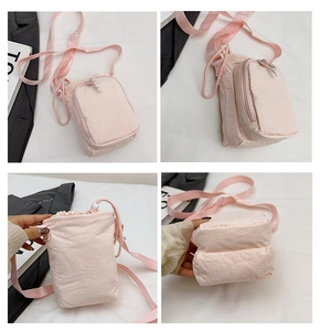 Multiple views of a pink nylon crossbody phone bag with drawstring and zipper pockets