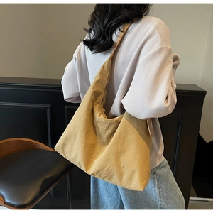 Model wearing a mustard yellow large tote bag showing the casual hobo style back view