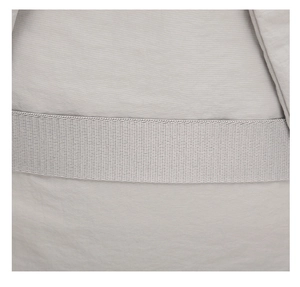 Detailed macro view of lightweight light grey nylon fabric with a durable woven strap