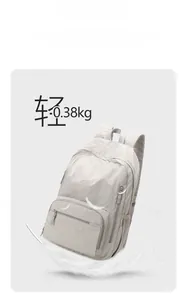 Ultralight grey nylon backpack weighing only 0.38kg shown with a white feather