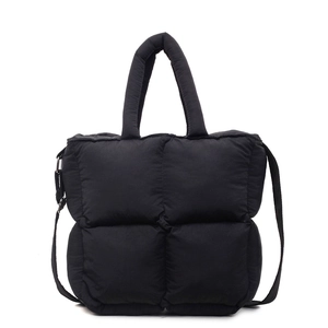 Black quilted puffer tote bag with a soft padded design and detachable shoulder strap