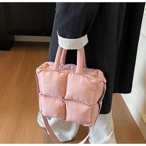 Detailed shot of light pink quilted puffer tote bag with soft space cotton texture