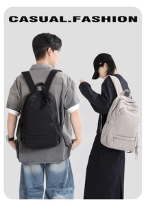 Detailed view of large waterproof travel backpacks in black and grey on models