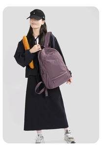 Detail of dark purple waterproof nylon backpack featuring a spacious multi-pocket design