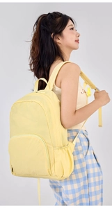 Light yellow foldable outdoor backpack showing side profile and shoulder strap detail