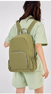 Detail of olive green foldable outdoor backpack with waffle texture and adjustable straps