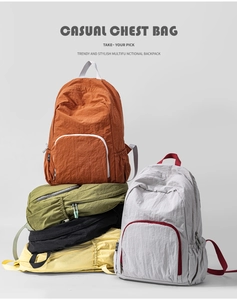 Detail showing foldable travel backpacks in five vibrant colors with nylon texture
