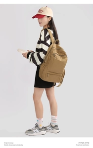 Side view of large khaki waterproof hiking backpack with multi-pocket storage and foldable design