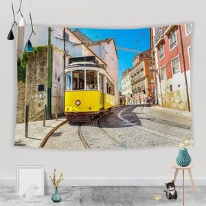 Detail of wall tapestry featuring a vintage yellow tram and European street architecture