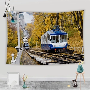 Detail of autumn landscape wall tapestry featuring a blue cable car and European architecture