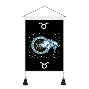 Detail of Taurus zodiac wall tapestry with bull illustration and black tassels