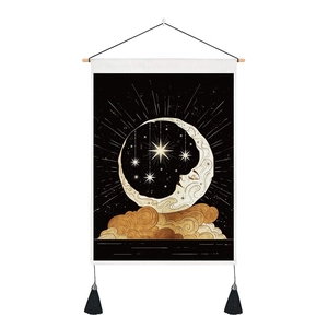 Detail of moon and stars wall tapestry with black fabric, wood rod and tassels