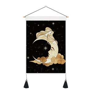 Detail view of cloud and moon wall tapestry with wood hanger and black tassels