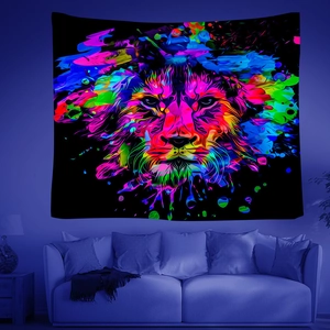 Detail of colorful neon abstract lion wall tapestry hanging above a sofa in a modern room