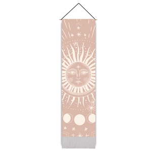 Detail of sun and moon phases print on a bohemian tapestry with wood rod and tassels