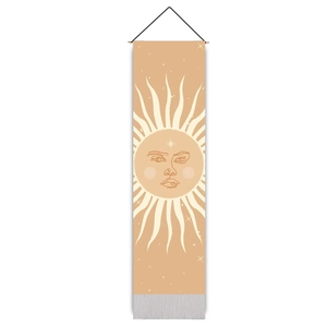Detailed view of sun face tapestry featuring bohemian fringe and wooden hanging rod